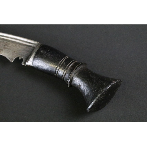 241 - A mid to late 20th century large Kukri knife, steel blade with twin grooved fullers, turned ebonised... 