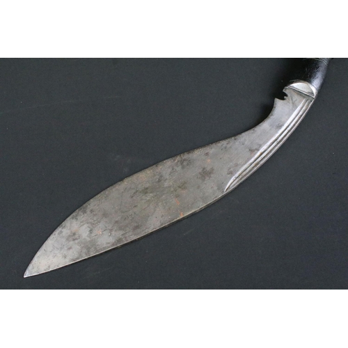 241 - A mid to late 20th century large Kukri knife, steel blade with twin grooved fullers, turned ebonised... 