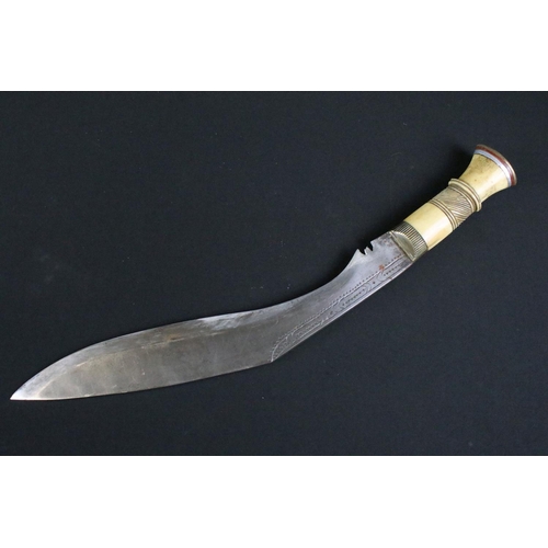 244 - A mid 20th century Kukri knife, steel blade with decorative dot engraving, turned bone handle, blade... 