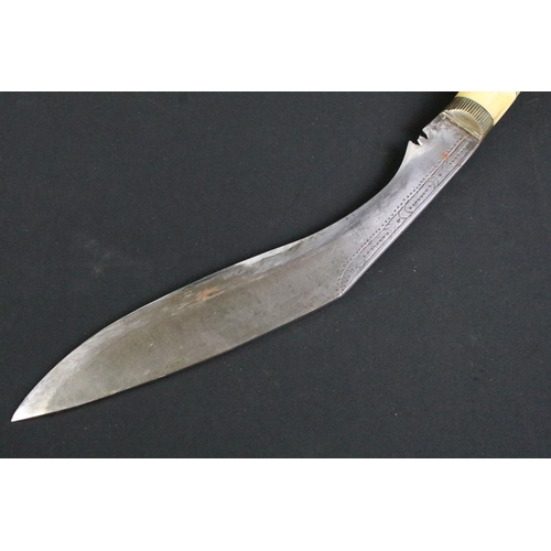 244 - A mid 20th century Kukri knife, steel blade with decorative dot engraving, turned bone handle, blade... 