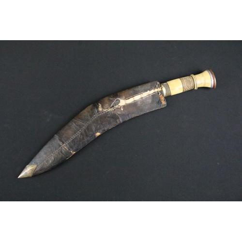 244 - A mid 20th century Kukri knife, steel blade with decorative dot engraving, turned bone handle, blade... 