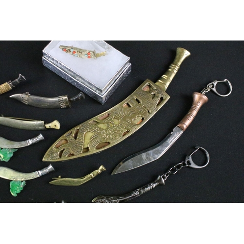 249 - A collection of Gurkha sweetheart brooches to include silver examples together with souvenir Kukri k... 