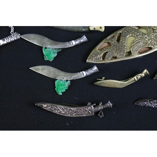 249 - A collection of Gurkha sweetheart brooches to include silver examples together with souvenir Kukri k... 