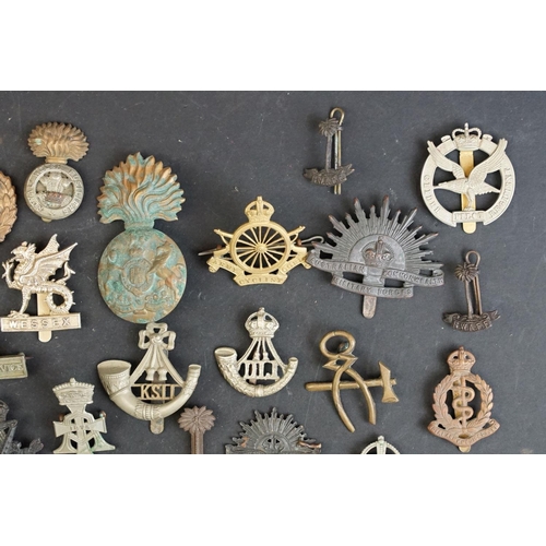 263 - A collection of approx fifty mainly British military regimental cap and collar badges to include the... 