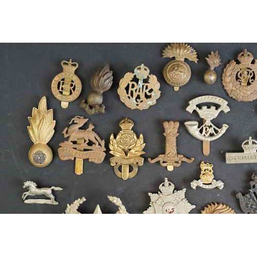 263 - A collection of approx fifty mainly British military regimental cap and collar badges to include the... 