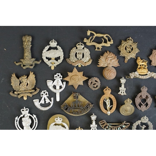 264 - A collection of approx fifty mainly British military regimental cap and collar badges to include the... 