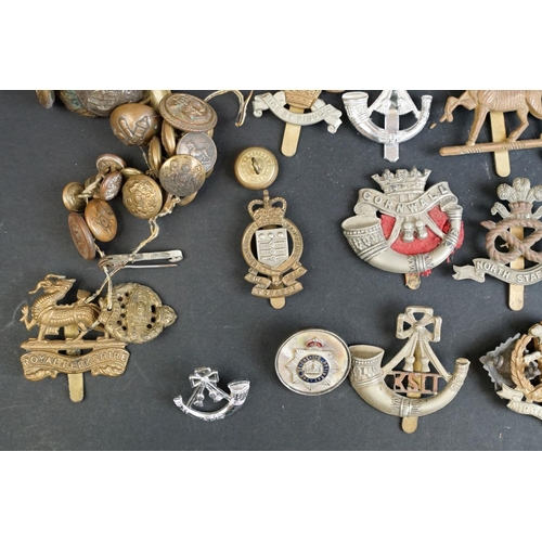 265 - A collection of over forty mainly British Regimental cap and collar badges together with a selection... 