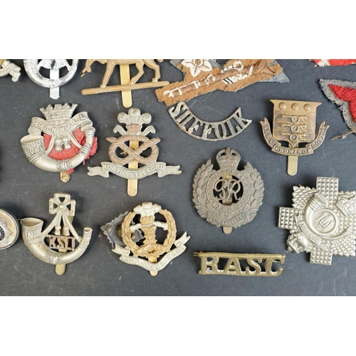 265 - A collection of over forty mainly British Regimental cap and collar badges together with a selection... 