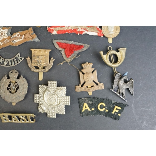 265 - A collection of over forty mainly British Regimental cap and collar badges together with a selection... 