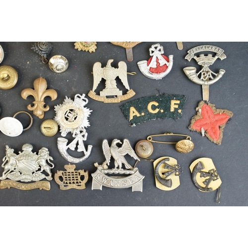 266 - A collection of over forty mainly British Regimental cap and collar badges together with a selection... 