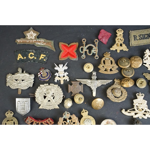 266 - A collection of over forty mainly British Regimental cap and collar badges together with a selection... 