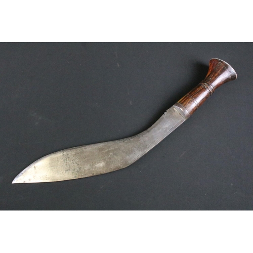 296 - A mid 20th century Kukri knife, steel blade with single grooved fuller stamped A.C. 1945, turned woo... 