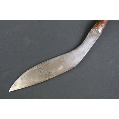 296 - A mid 20th century Kukri knife, steel blade with single grooved fuller stamped A.C. 1945, turned woo... 