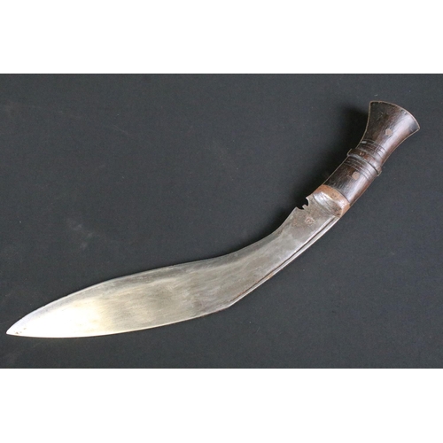 298 - An early to mid 20th century Kukri knife, steel blade with single groove fuller and sun face stamp, ... 