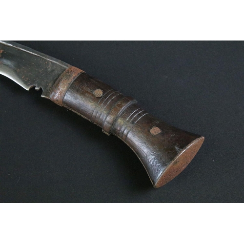 298 - An early to mid 20th century Kukri knife, steel blade with single groove fuller and sun face stamp, ... 