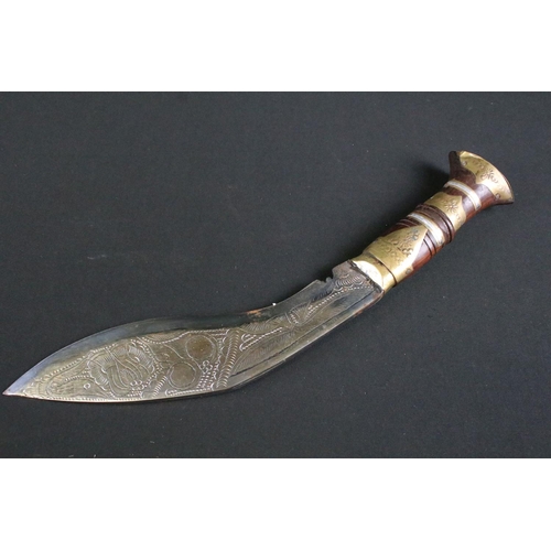 305 - A Nepalese tourist Kukri knife, highly decorative polished steel blade, turned wooden handle with br... 