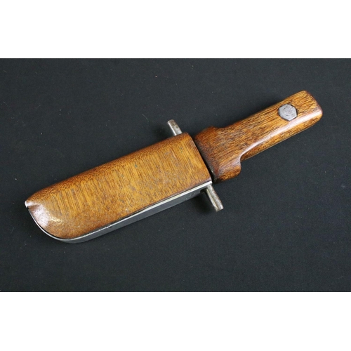 320 - A mid to late 20th century handmade fighting knife, steel blade on two piece wooden handle with matc... 