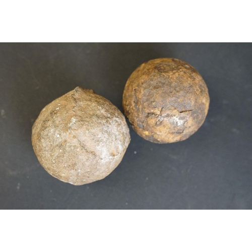 335 - A British World War One / WW1 18 P.R. brass artillery shell together with two antique canon balls.