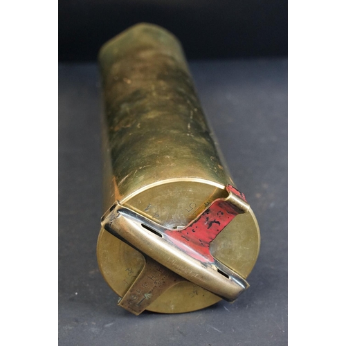 335 - A British World War One / WW1 18 P.R. brass artillery shell together with two antique canon balls.