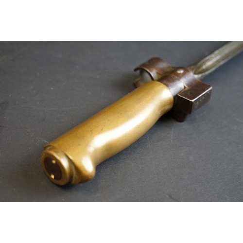 353 - A French Model 1886/15 sword bayonet, cruciform blade, brass handle, complete with metal scabbard an... 