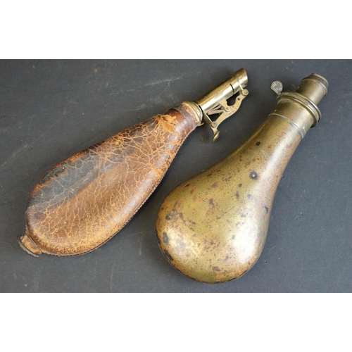 355 - Two antique powder / shot flasks to include a brass and a leather example.