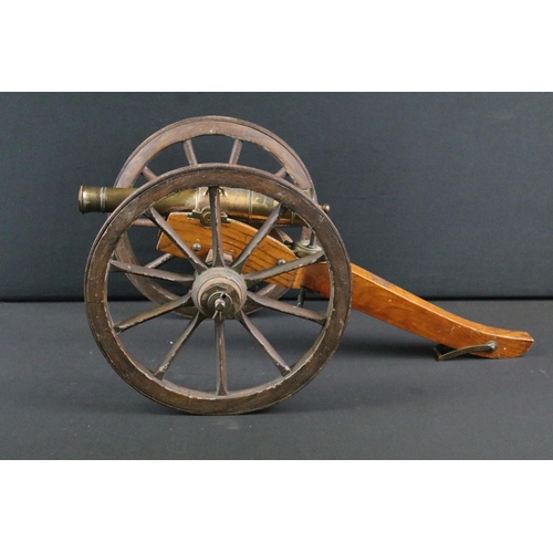 369 - A brass signal cannon mounted to wooden carriage with brass fittings, barrel length approx 26.5cm, o... 