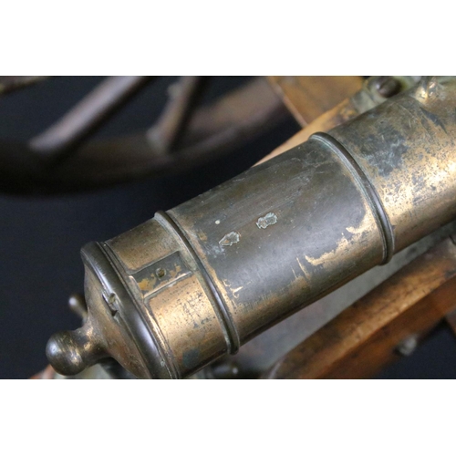 369 - A brass signal cannon mounted to wooden carriage with brass fittings, barrel length approx 26.5cm, o... 