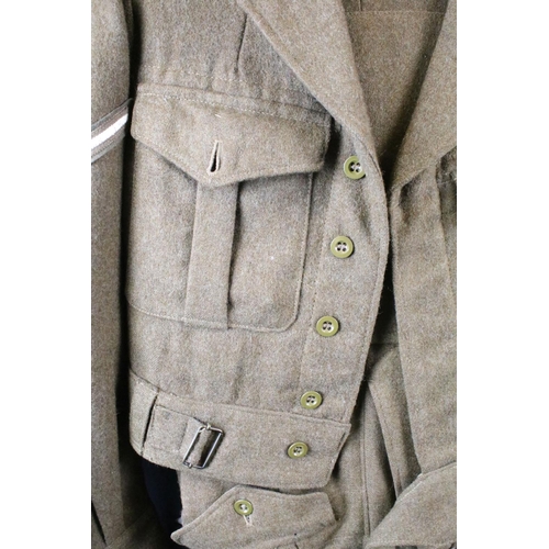 370 - A British military issued battle dress uniform comprising of blouse and trousers, dated 1954 and com... 