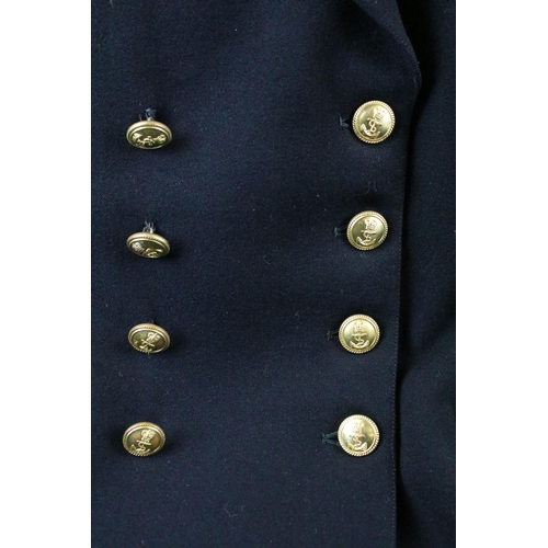 371 - A British Royal Navy uniform comprising of jacket and trousers and complete with buttons and badges,... 