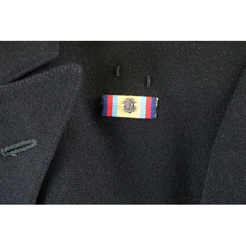 371 - A British Royal Navy uniform comprising of jacket and trousers and complete with buttons and badges,... 