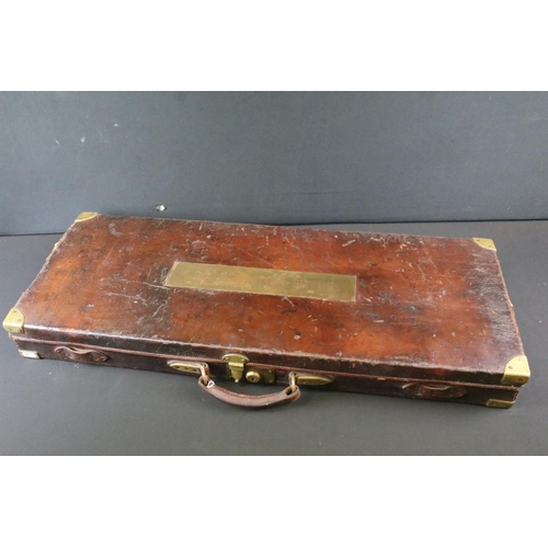 377 - A brown Leather gun case measuring 84cm x 34cm x 8cm with fitted intirior and having an internal Lab... 