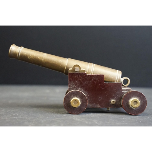 383 - A pair of ornamental brass cannon's mounted to bakelite carriages.