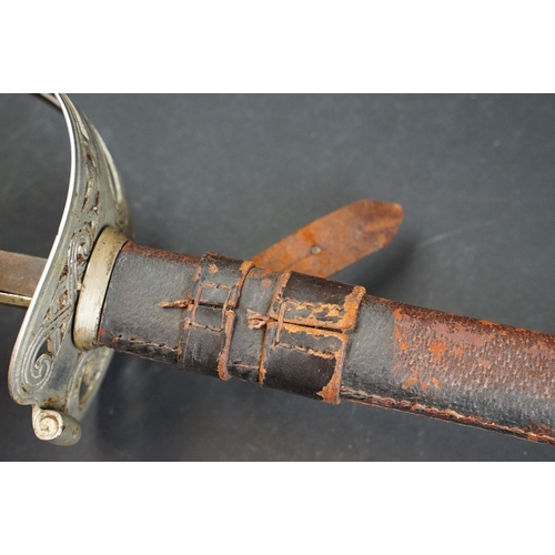 397 - A British 1822 pattern Coldstream guards officer sword complete with leather sheath (A/F)