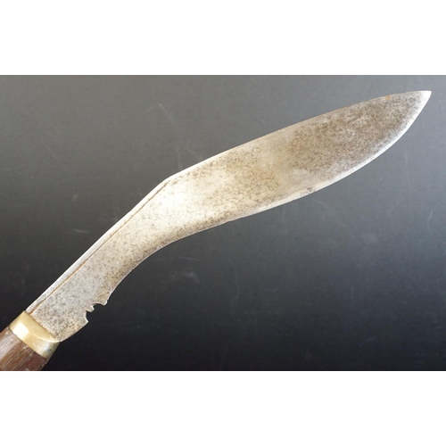 40 - A standard issue (BSI) Kukri knife, no markings to blade, wooden handle and white metal fittings, wi... 