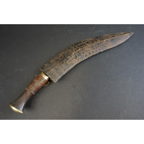 40 - A standard issue (BSI) Kukri knife, no markings to blade, wooden handle and white metal fittings, wi... 