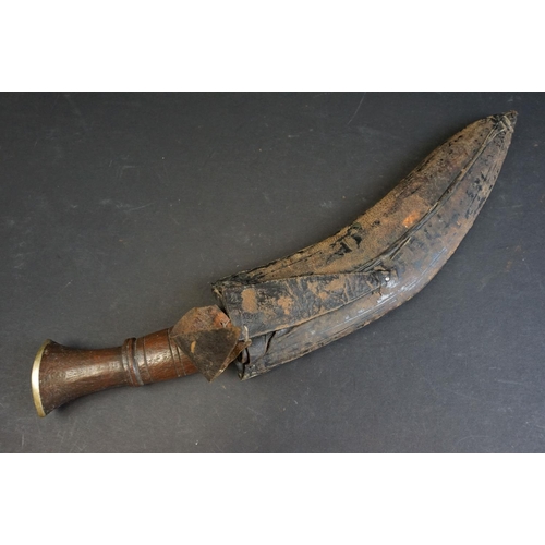 40 - A standard issue (BSI) Kukri knife, no markings to blade, wooden handle and white metal fittings, wi... 