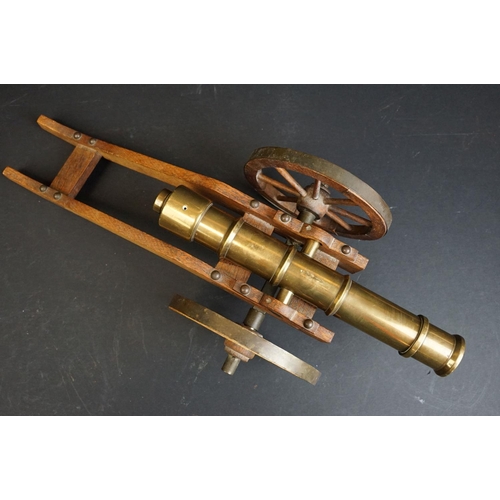 401 - A brass signal cannon mounted to wooden carriage with brass fittings, barrel length approx 29.5cm, o... 