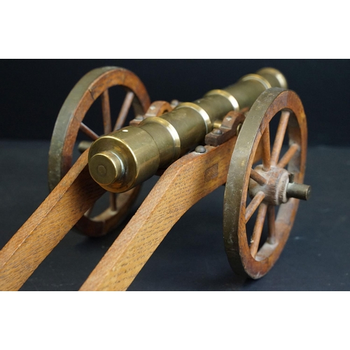 401 - A brass signal cannon mounted to wooden carriage with brass fittings, barrel length approx 29.5cm, o... 