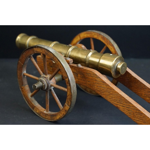 401 - A brass signal cannon mounted to wooden carriage with brass fittings, barrel length approx 29.5cm, o... 