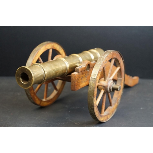 401 - A brass signal cannon mounted to wooden carriage with brass fittings, barrel length approx 29.5cm, o... 