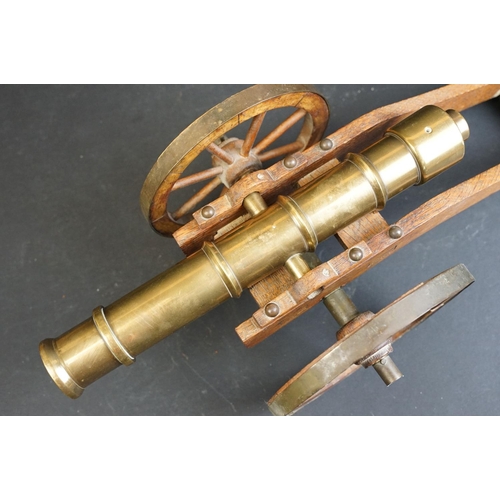 401 - A brass signal cannon mounted to wooden carriage with brass fittings, barrel length approx 29.5cm, o... 