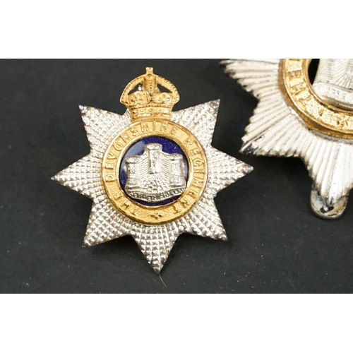 407 - A British The Devonshire Regiment officers cap badge with Queens Crown together with a pair of The D... 