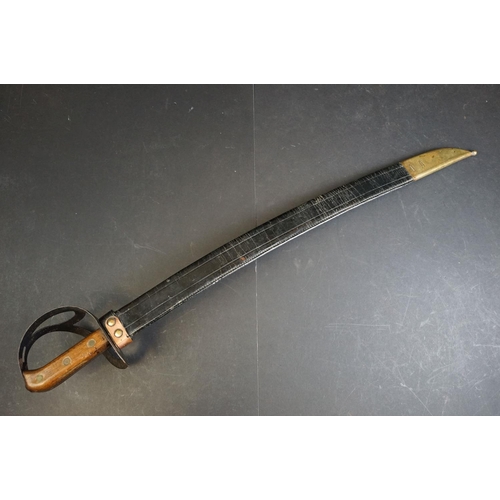 411 - A Dutch Klewang Sword / Machete, 62.5cm curved fullered blade with clipped back point, pierced sheet... 