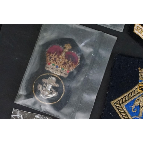 421 - A collection of British Royal Navy cloth badges to include HMS Ganges & HMS Surprise examples togeth... 