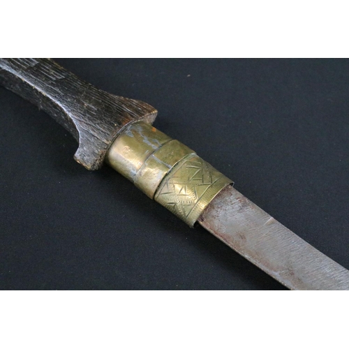 426 - A Moroccan Jambiya knife within brass scabbard together with a gun magazine.