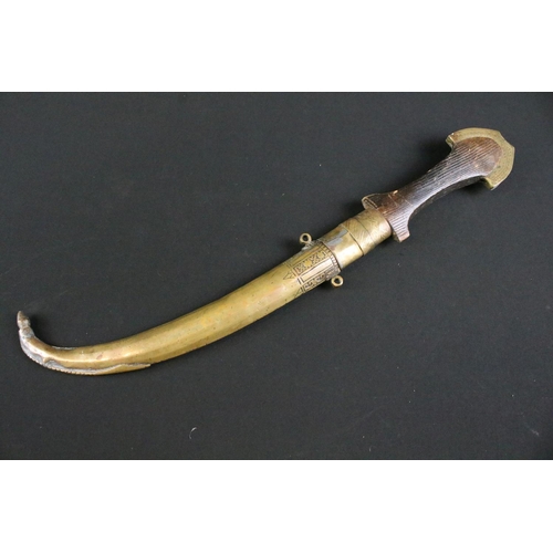 426 - A Moroccan Jambiya knife within brass scabbard together with a gun magazine.