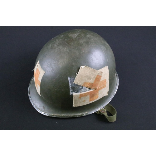 438 - A collection of three military steel helmets together with a russian fur hat.