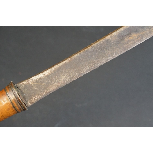 443 - A primative large machete type knife, overall length is approx 77cm.