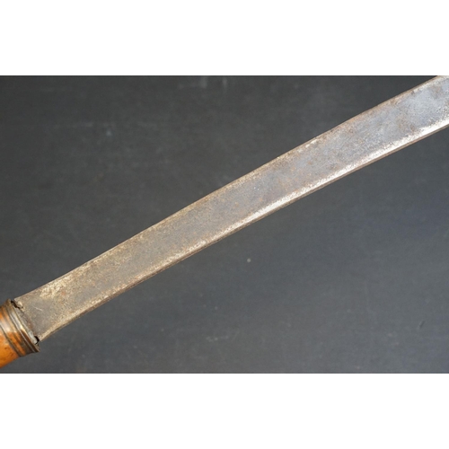 443 - A primative large machete type knife, overall length is approx 77cm.