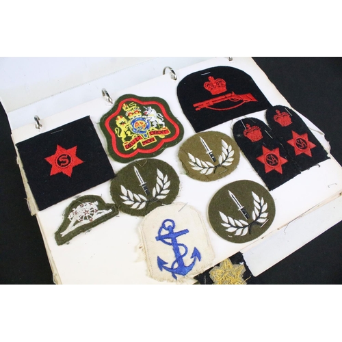 458 - A collection of mainly British military cap badges, cloth badges and buttons contained within two fo... 